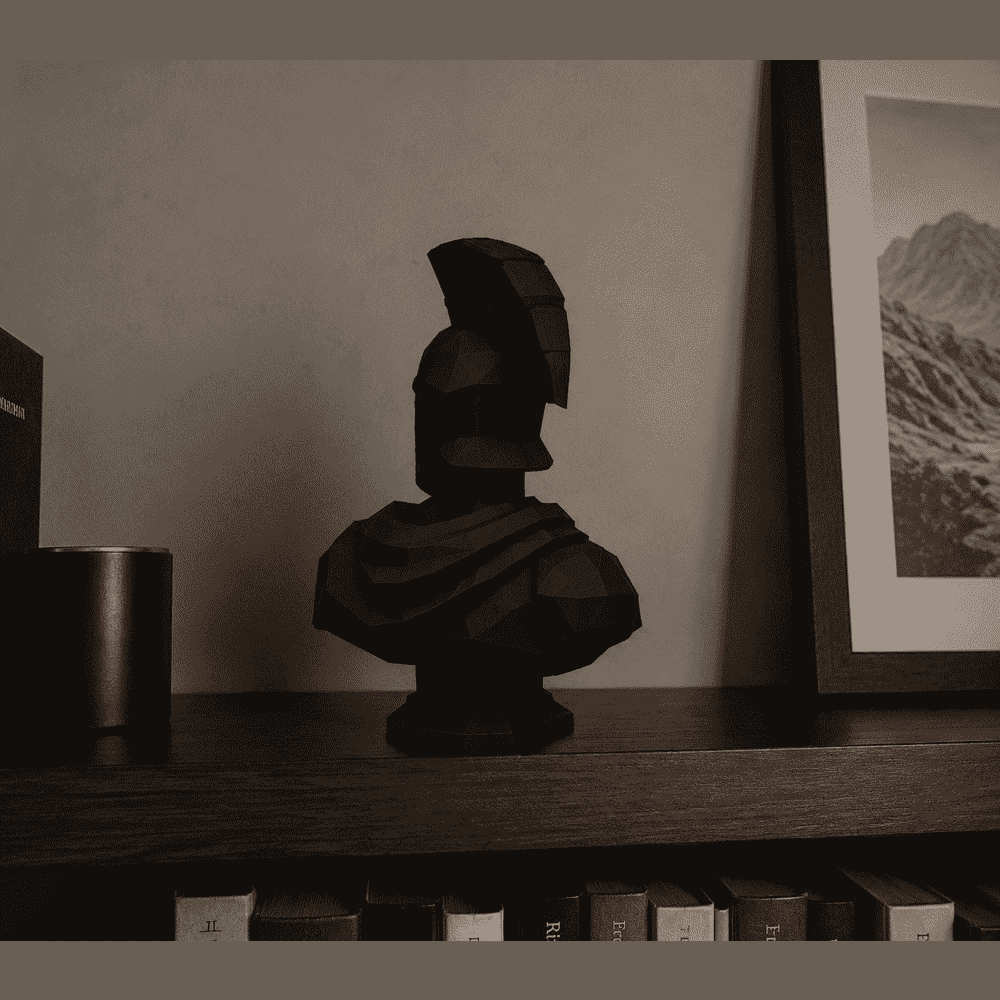 Low-Poly Spartan Bust — Matte Black Resin Collectible Sculpture. The courage of ancient Sparta, reduced to pure geometry. A Spartan warrior bust reimagined in low-poly style: sharp clean facets and matte black finish. Taraflo Taraflo Low-Poly Spartan Bust