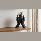 Whisper of the Void — 'Hands' Sculptural Vase in Matte Black Resin (30 cm): Two hands cradling the void, turning it into art. A tribute to human anatomy and contemporary design