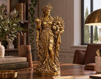Statua color oro della dea greca con corona di grano e fiori che regge un melograno